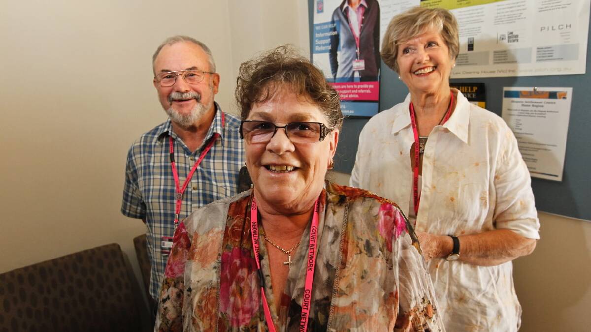 Recruit Hilde, front, five-year volunteer Neal and Court Network program manager Betty Renfree would welcome more volunteers. Picture: BEN EYLES