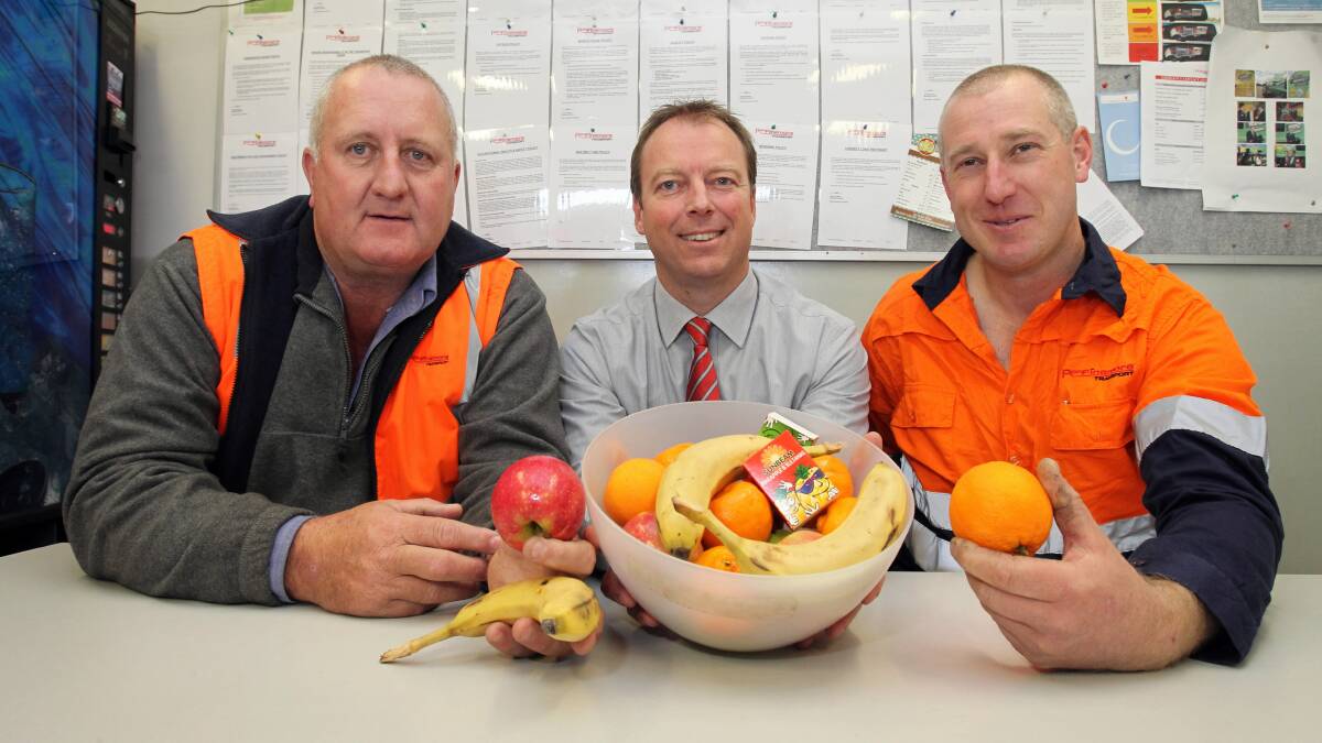 Ron Finemore Transport’s Bryan Mann, Dave Coleman and Ray Pitt ... fruit bowls are now a feature around the office for staff to enjoy a healthy snack. Pictures: MARK JESSER