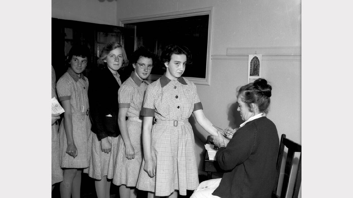 St Joseph’s girls line up to immunised at school, 1950s.