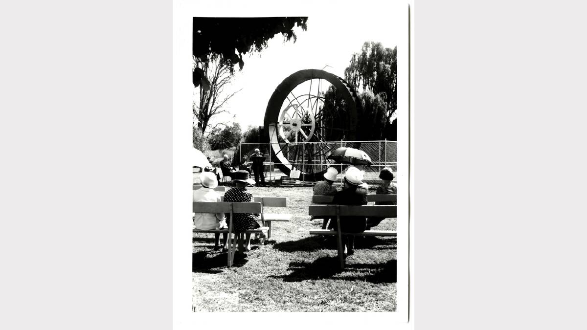 Waterwheel in its original setting in Australia Park, Albury. Percy Burrows at microphone at the opening on November 21, 1969. Claude Hazelwood at left in dark suit. Cleaver Bunton, also seated. Ladies on garden seats include Lila Quiggan in spotted dress left, Maisie Hazelwood front right. Picture: ALBURYCITY COLLECTION