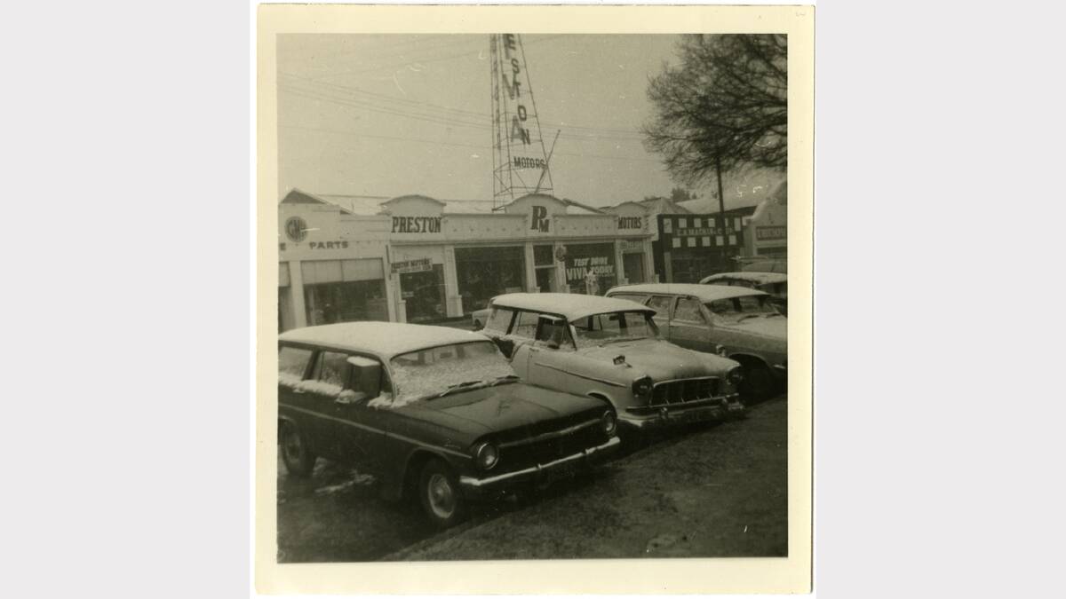 1960s image of Preston Motors taken from the west side of Kiewa Street, Albury, with four parked cars at front of image, each car with snow on roof and windows. Picture: ALBURYCITY COLLECTION