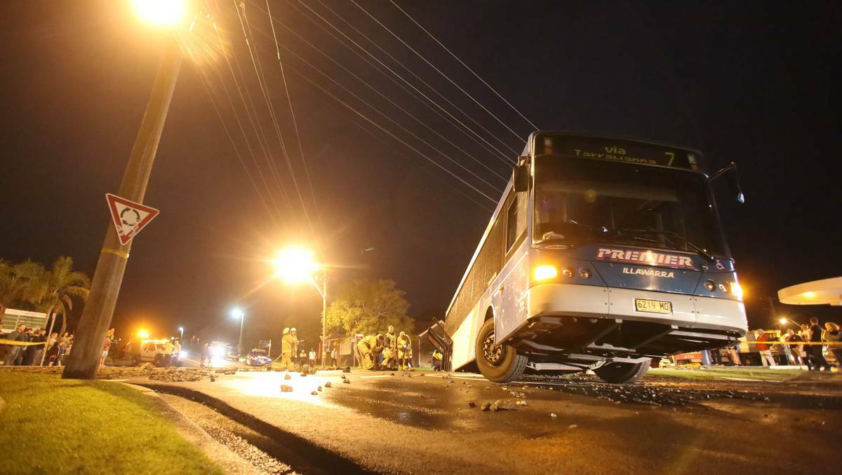 A burst water main tries to swallow the No 7 bus to Tarrawanna at the corner of Balgownie and Foothills Rd, opposite the Fuel Power Plus petrol station. Pictures: David Finlay, Illawarra Mercury