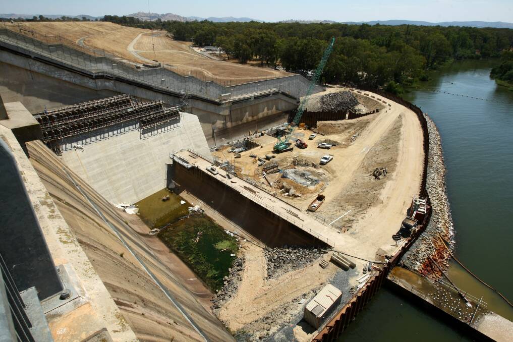 The new wall rises against the old embankment and above the retarding basin at the foot of the spillway. Picture: MATTHEW SMITHWICK.