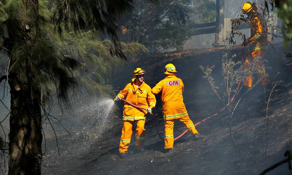 Firefighters took little time mopping up the fire near the Hume Freeway yesterday afternoon. Pictures: MATTHEW SMITHWICK