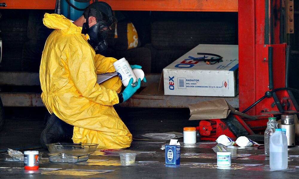 Forensic police photograph evidence inside the alleged drug lab. Pictures: Matthew Smithwick.
