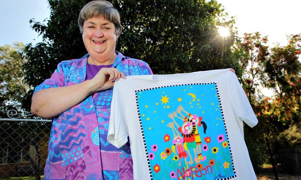 Christine Stewart with a t-shirt she had made to promote Happy Healthy Children.