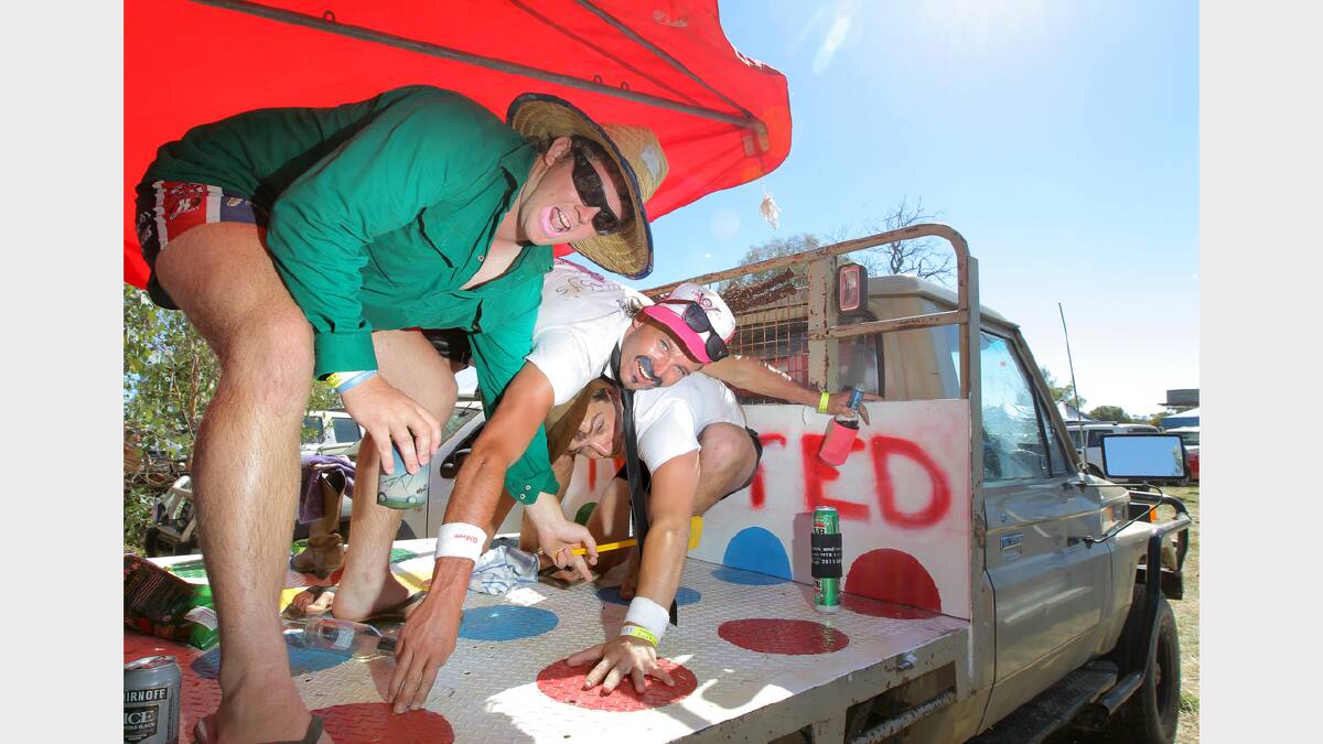 Joe Briggs, of Morundah Heights, Roly Paterson, of Stockinbingal, and Hamish McGeoch, of Katherine. Joe and Hamish painted the Twister board game onto the back of Joe's ute, in the hope that some girls would come and play! At the Holbrook B&S. PICTURE: Tara Goonan.