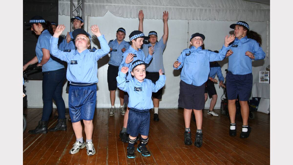 Students from the Wewak St School, including their youngest star, Cody Sedgelow, 5 (front, centre), perform for the crowd at the fundraiser being held for the school's benefit at the Albury Gold Cup Carnival.
