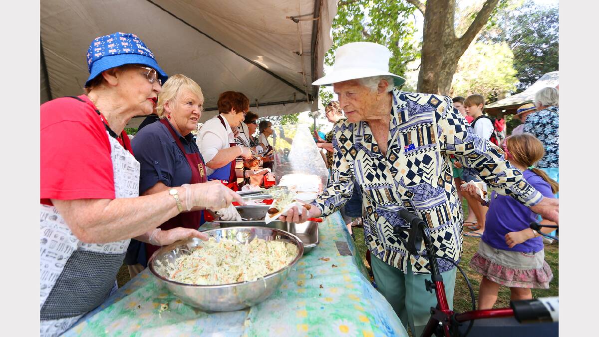 Wangaratta. Verna Beckley helps Marjorie Booth, 89, at the BBQ. PICTURE: John Russell.