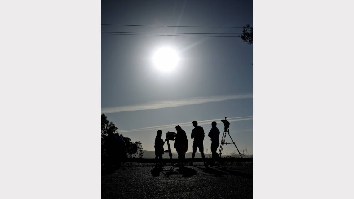 Telescopes at the ready, the Eastern Hill mob await yesterday’s partial eclipse. PICTURE: Ben Eyles.