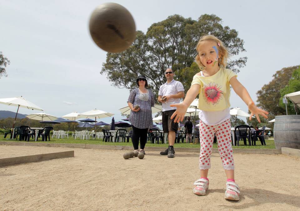 LA DOLCE VITA: Charlotte Bongers, 4, of Wangaratta, has a go at bocce while her parents Michelle and Marc Bongers watch on. PICTURE: Matthew Smithwick.