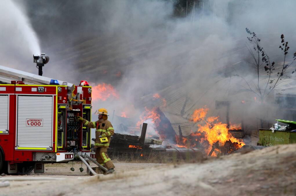 Fire crews battle the blaze at the Weatherall Masonry site on the Lincoln Causeway. Picture: BEN EYLES.