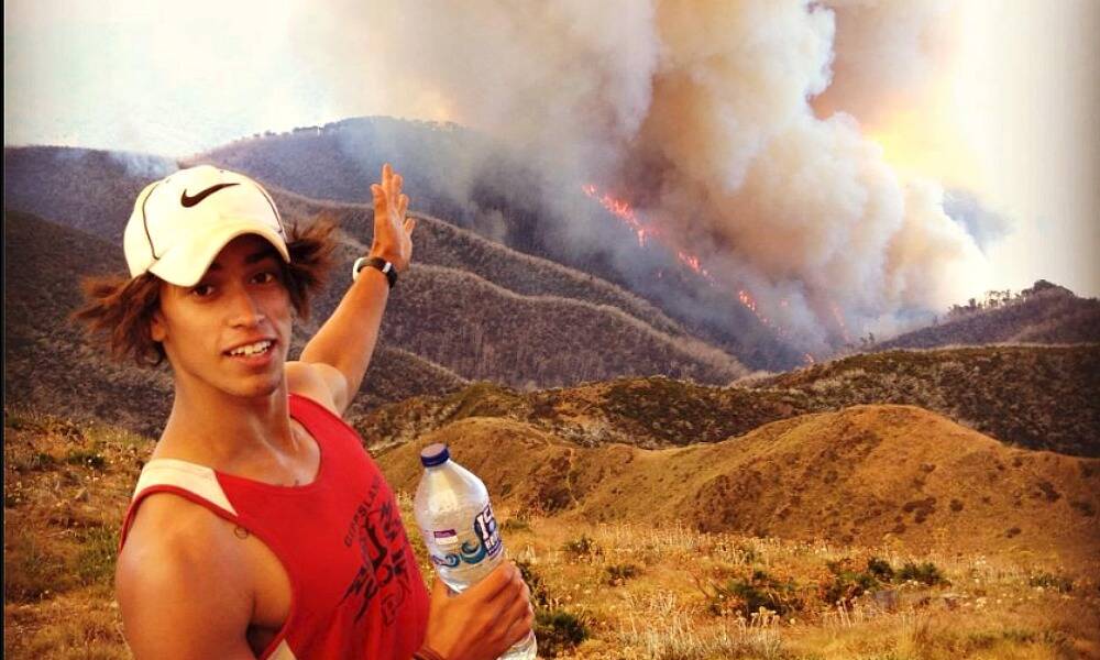 Gippsland Power footballer Josh Cashman shows how close the fire came to Mount Feathertop hikers.