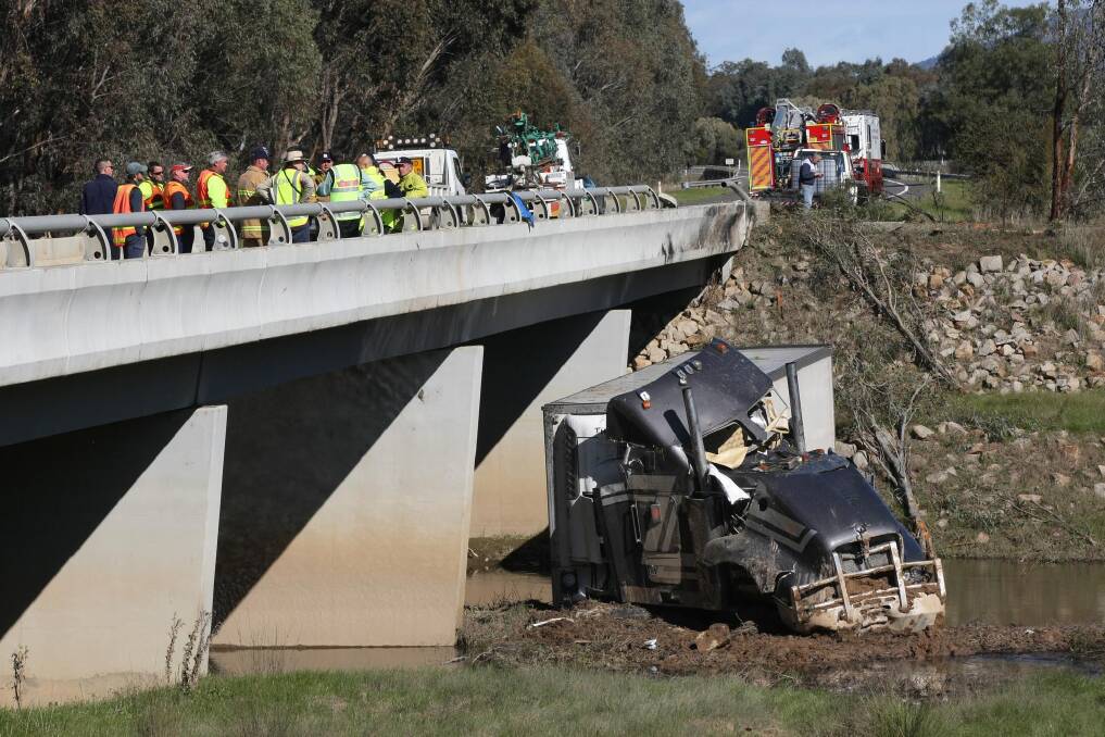Both south-bound lanes of the Hume Freeway near Wangaratta are closed after a truck smashed into a tree and landed in a creek.