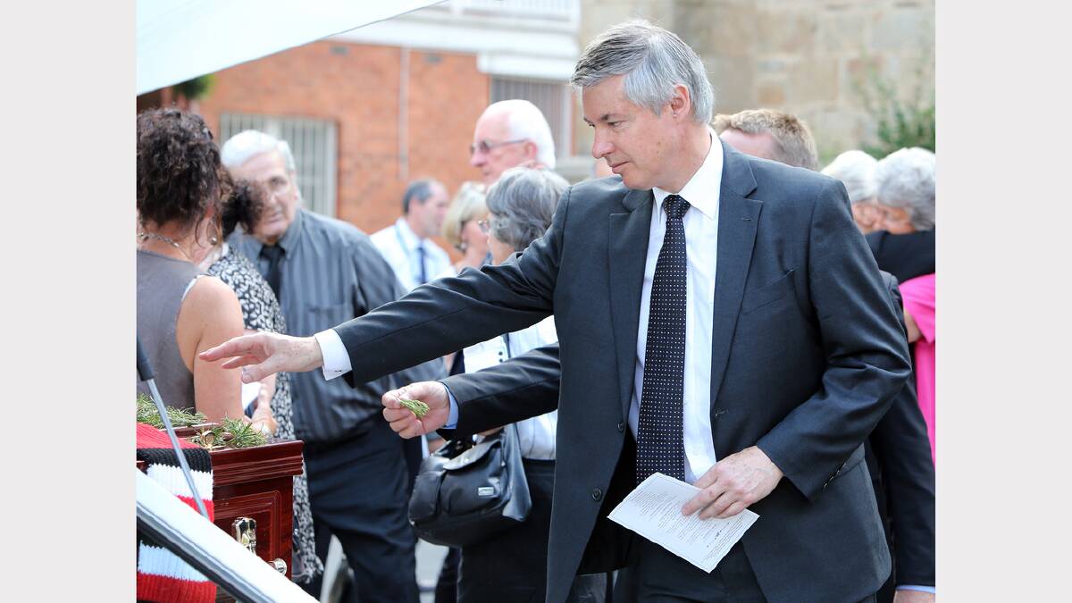 Member for Albury Greg Aplin places a sprig of rosemary on the casket. PICTURES: Kylie Esler.