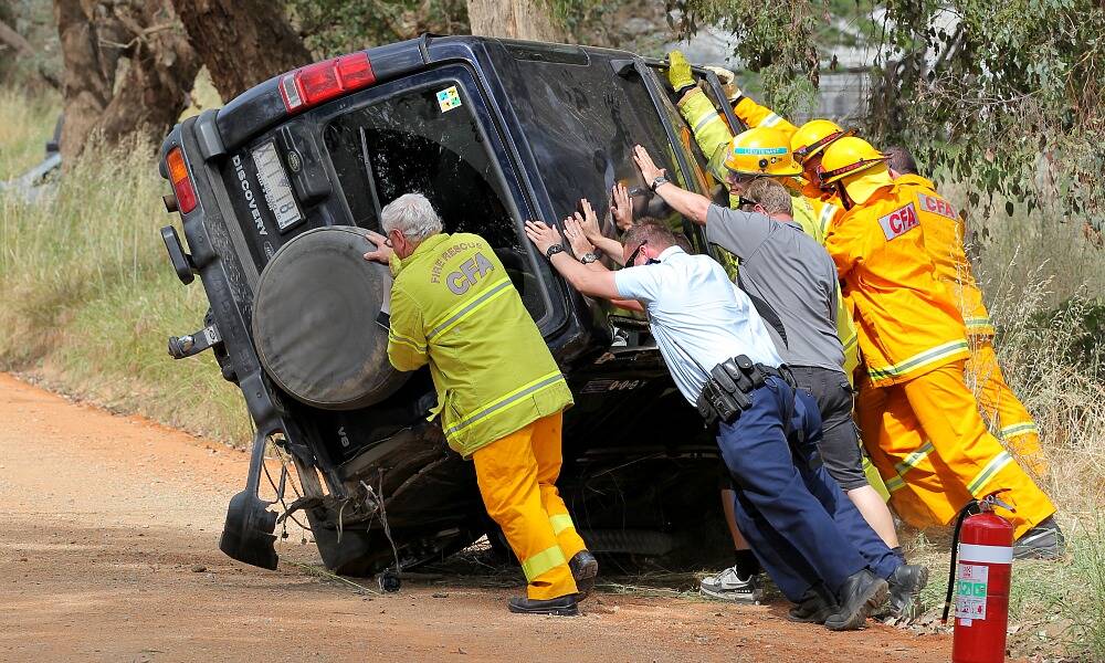 Police and emergency services tip the 4WD back to all four wheels. PICTURE: David Thorpe.