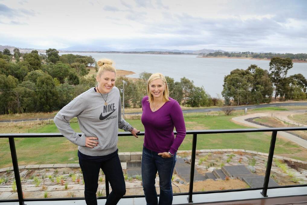Lauren Jackson and Better Homes and Gardens host Johanna Griggs enjoy the lakeside views from the balcony of the basketballer’s new two-storey Bellbridge home.