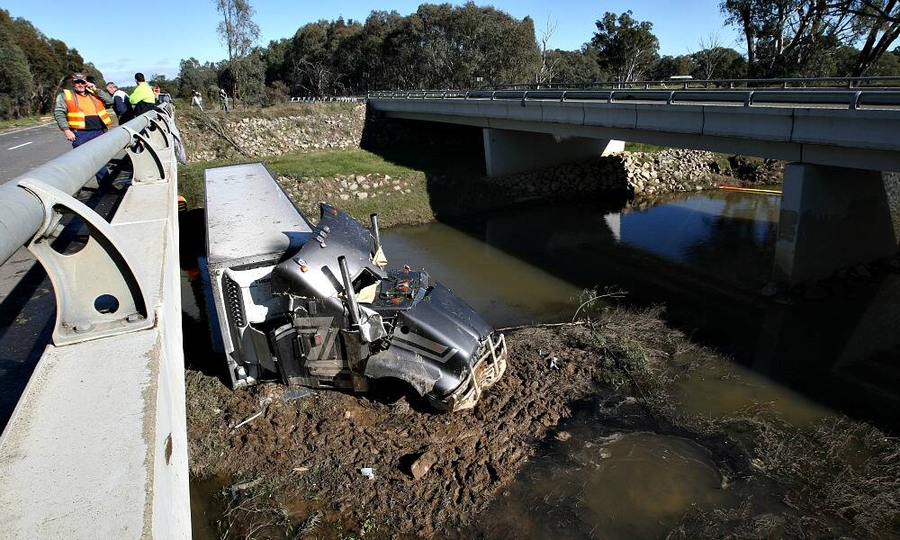 Both south-bound lanes of the Hume Freeway near Wangaratta are closed after a truck smashed into a tree and landed in a creek.
