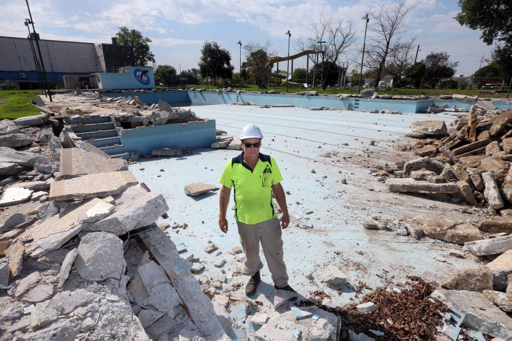Brian Hoysted stands in the 50-metre pool being demolished at Wodonga’s old swimming centre in Stanley Street. Pictures: PETER MERKESTEYN