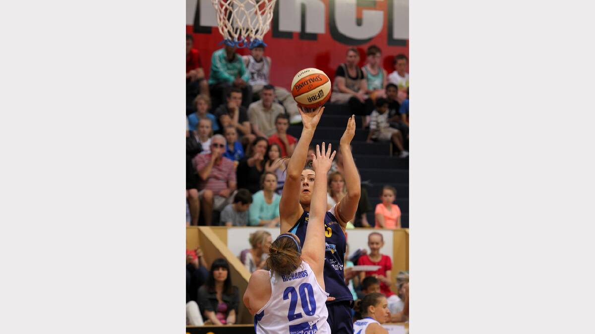 Canberra's Alex Bunton (no. 13) shoots for goal over the top of Bendigo's Gabrielle Richards during the WNBL match between Canberra Capitals and Bendigo Spirit at the Lauren Jackson Sports Centre. PICTURE: Matthew Smithwick.