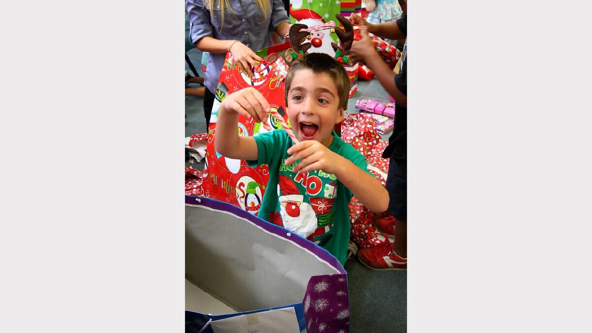 Jaryn Trainor, thrilled about receiving a candy-cane among his Christmas presents sent by the students of Castle Hill High School in Sydney. 