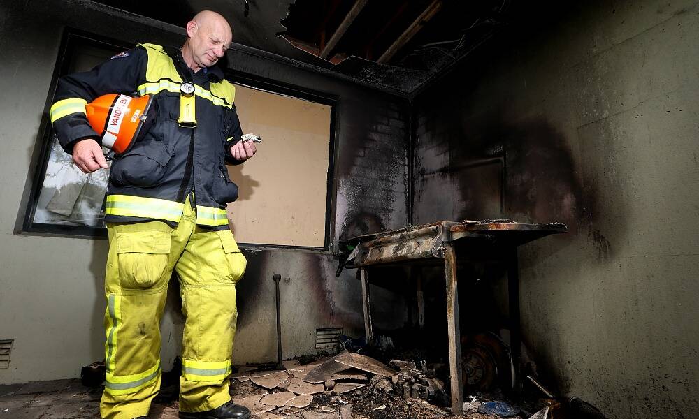 John Vandeven, captain of Albury Civic Fire Brigade, inspects the barbecue that caught fire and the damage it caused to an Ebden Street property. No one was hurt in the fire. Picture: KYLIE ESLER