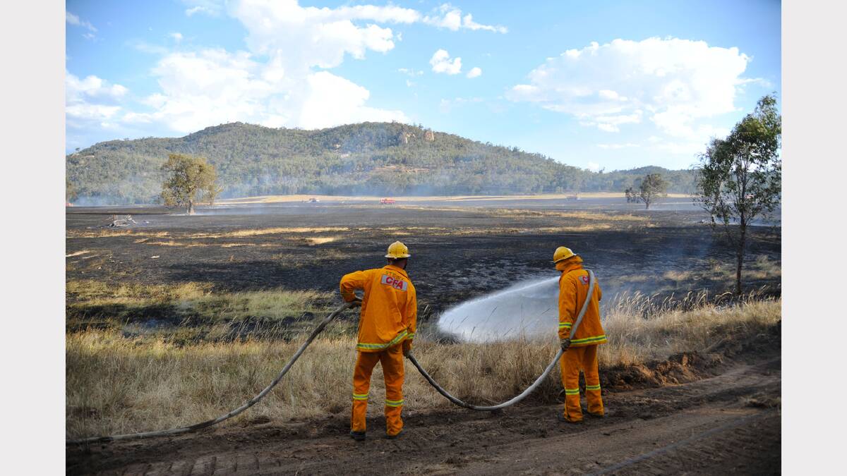 Firefighters mop up a fire on a property near Chiltern. There were fears it would spread into Mount Pilot National Park. Pictures: JOHN RUSSELL