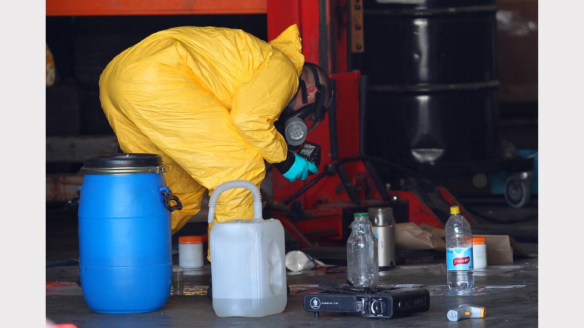Forensic police photograph and seize evidence inside the alleged drug lab. Pictures: Matthew Smithwick