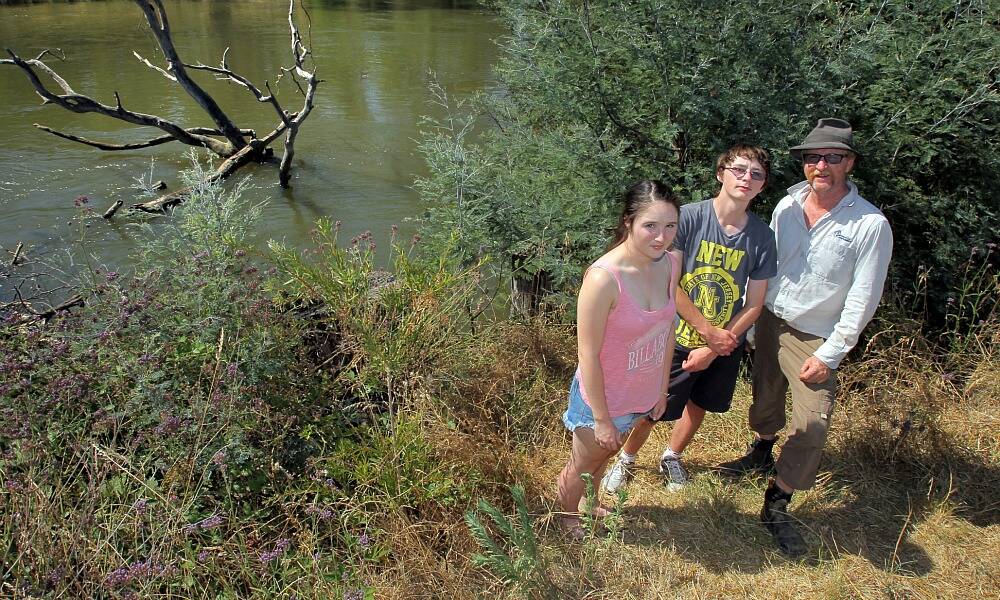 David Hawkins, with his children Lily and Angus, at the bank of the river where the woman was rescued. The family is concerned that some paddlers on the river aren’t properly experienced or equipped. Picture: TARA GOONAN