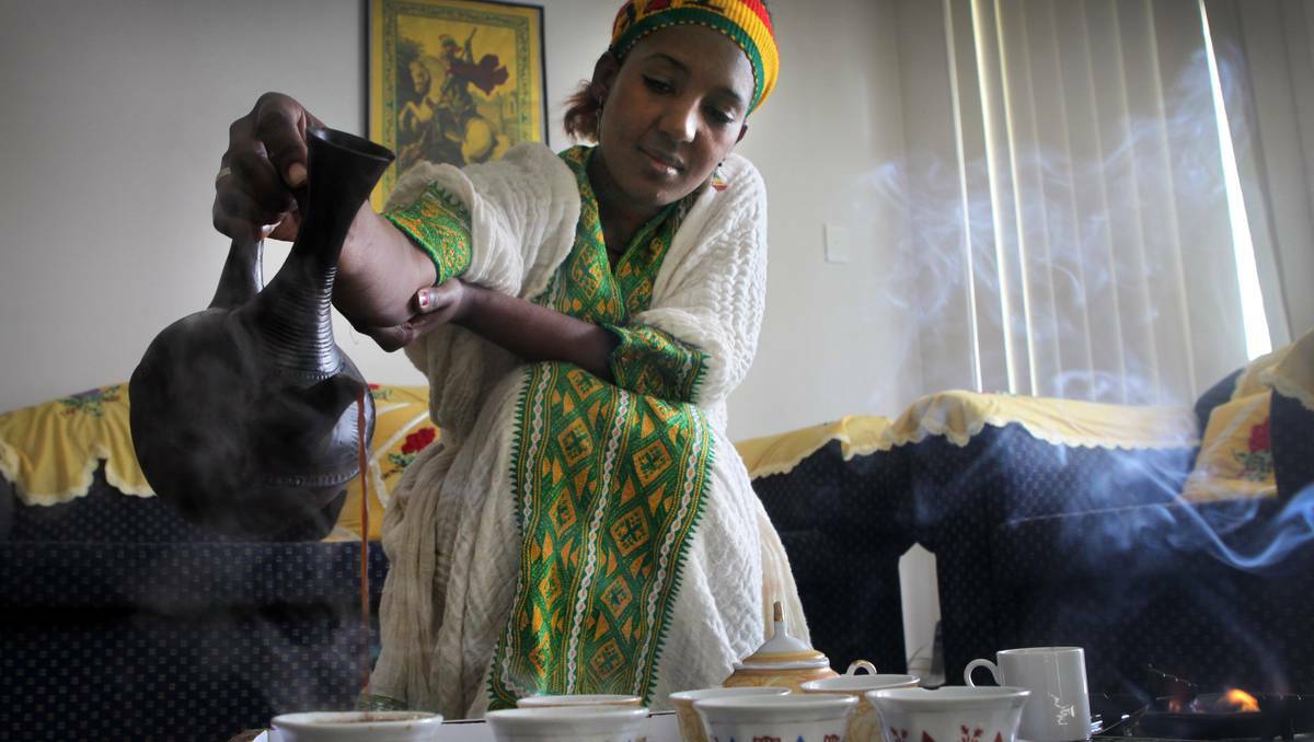 Ms Wosen serves the traditional Ethiopian coffee for her guests. Picture: Illawarra-Mercury