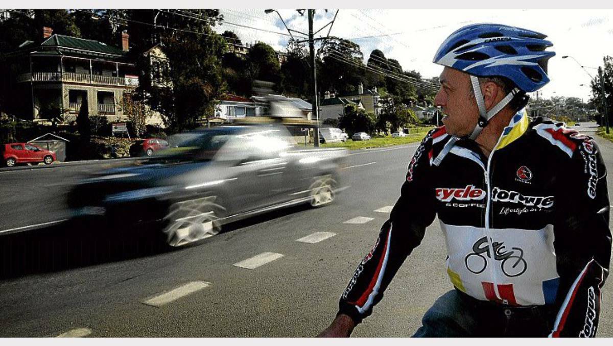 Cyclist John Spucces on the West Tamar Highway. A proposal to have a minimum passing distance has been rejected by the state government. Picture: Geoff Robson