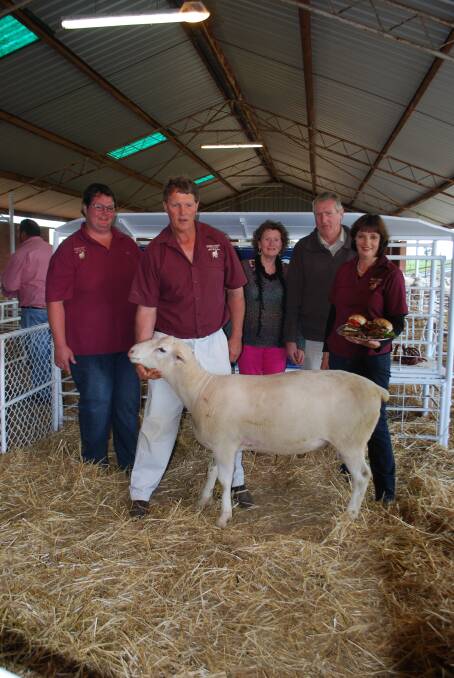 Nicholas Craig, son of principals Brian and Donna Craig, Brian Craig, buyers Sheena and Mark Schmidt and Donna Craig with the top-priced ram at the sale