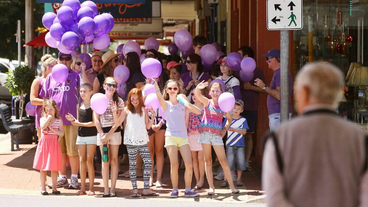 Lauren Antonello, 10, of Albury, Indiah Hallows, 10, of Albury, and Monae Scott-Coutts, 10, of Wodonga, lead the walk as they wait for the lights to change at David Street yesterday. Picture: BEN EYLES