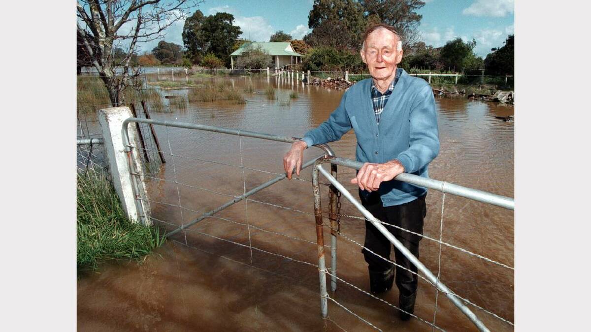 Joe Williamson in front of his Wangaratta home surrounded by water.Picture: PETER MERKESTEYN