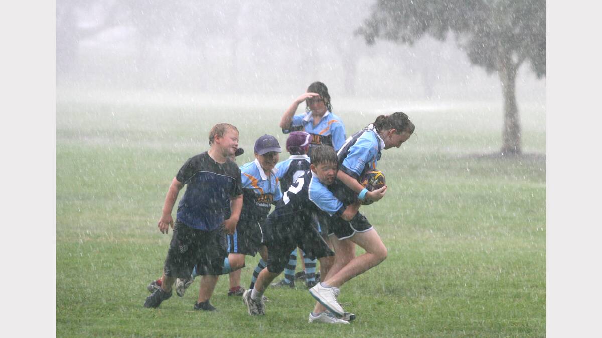Children play  in Willow Park, Wodonga while a clinic by The Storm rugby team is redirected due to wet weather. February, 2008.