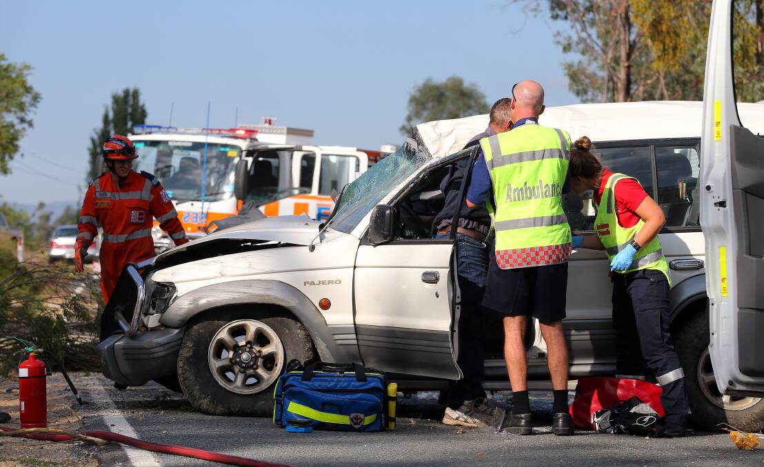 Rescue workers attend the scene of the crash. Picture: JOHN RUSSELL
