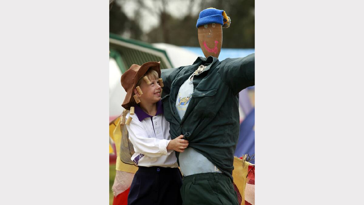Wodonga Guides member Rochelle Smith, 7, with one of the scarecrows from their team "Our Backyard Tent".