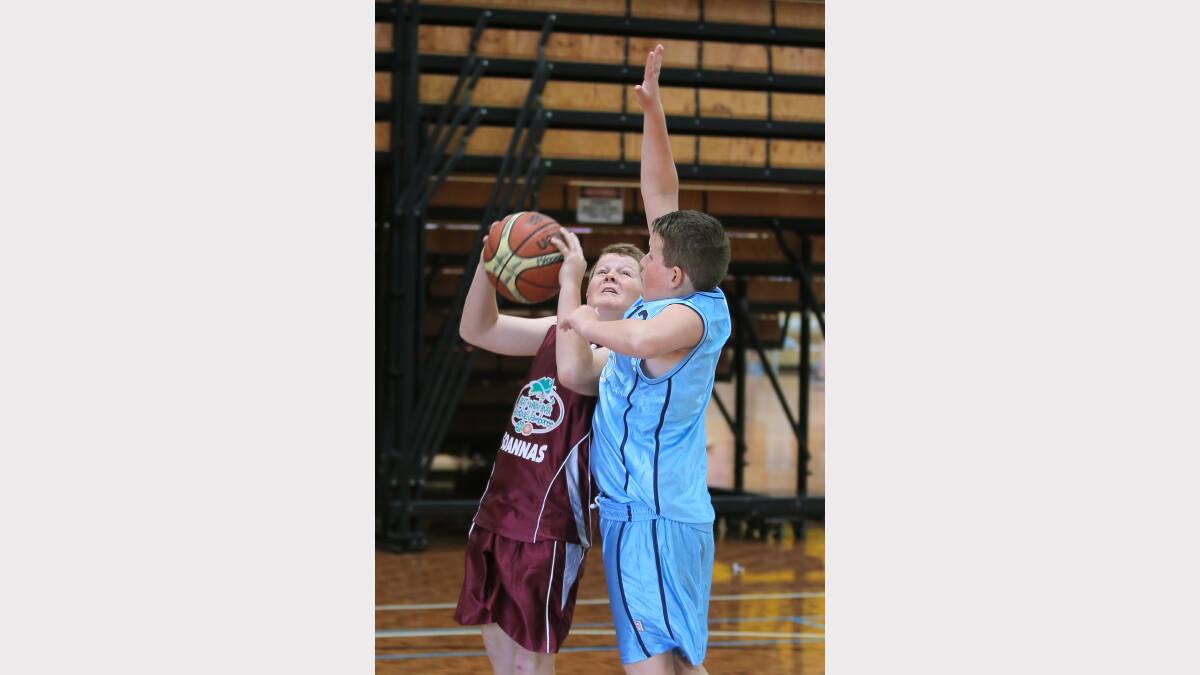 Will Unthank, of Albury, tries to move the ball past the defence of Colby Kennedy, of Traralgon.