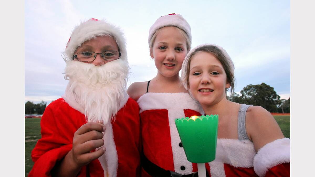 Santa (a.k.a Connor Flavell 9) with friends Taylor Donelan, 10, and Elley Donelan, 7.