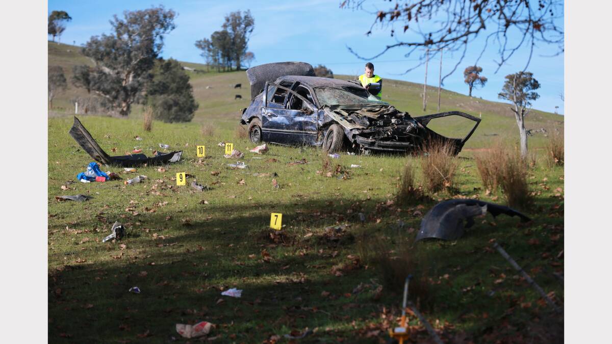 Police investigate the scene of an accident where four men were injured. Pictures: JOHN RUSSELL