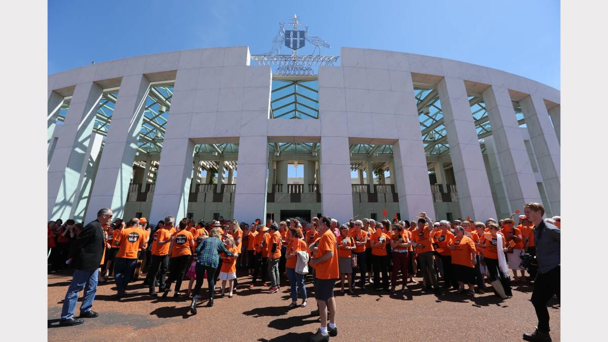 A sea of orange as supporters of Member for Indi Cathy McGowan wait outside Parliament House in Canberra. 