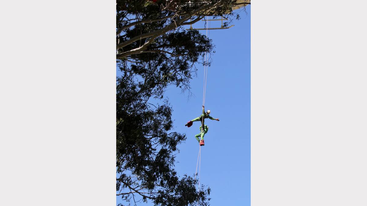 Rappel crews lower themselves to the ground via ropes. 