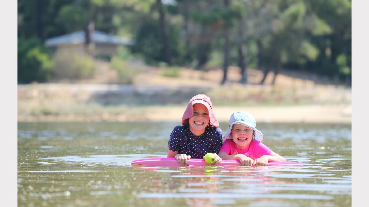 Sisters Annabele and Clare Martinae, aged 10 and 7, cool off at Beechworth. 