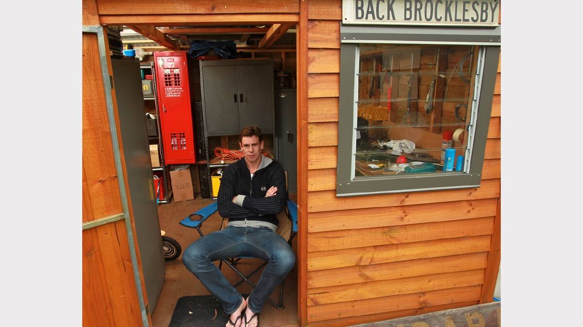 Saints player Justin Koschitzke at home in his backyard shed hideaway, complete with locker stolen from Moorabbin oval and Back Brocklesby road sign. Picture: FAIRFAX