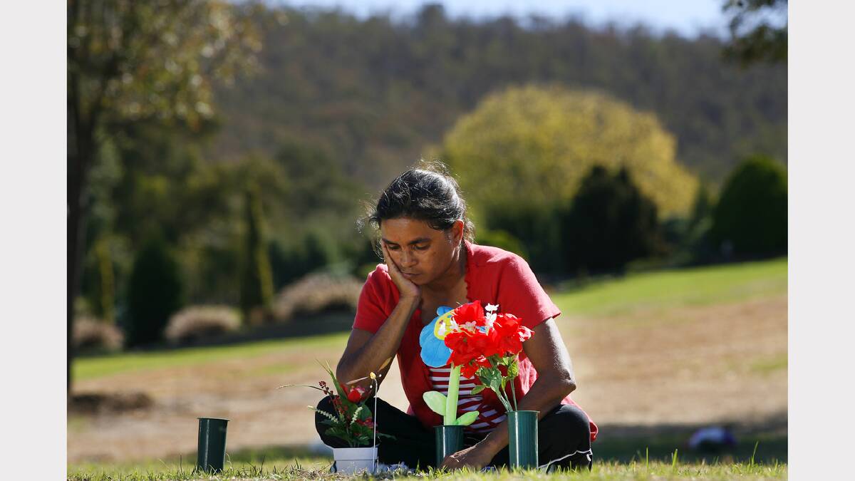 2009 - Donna Thomas puts flowers on her son's grave