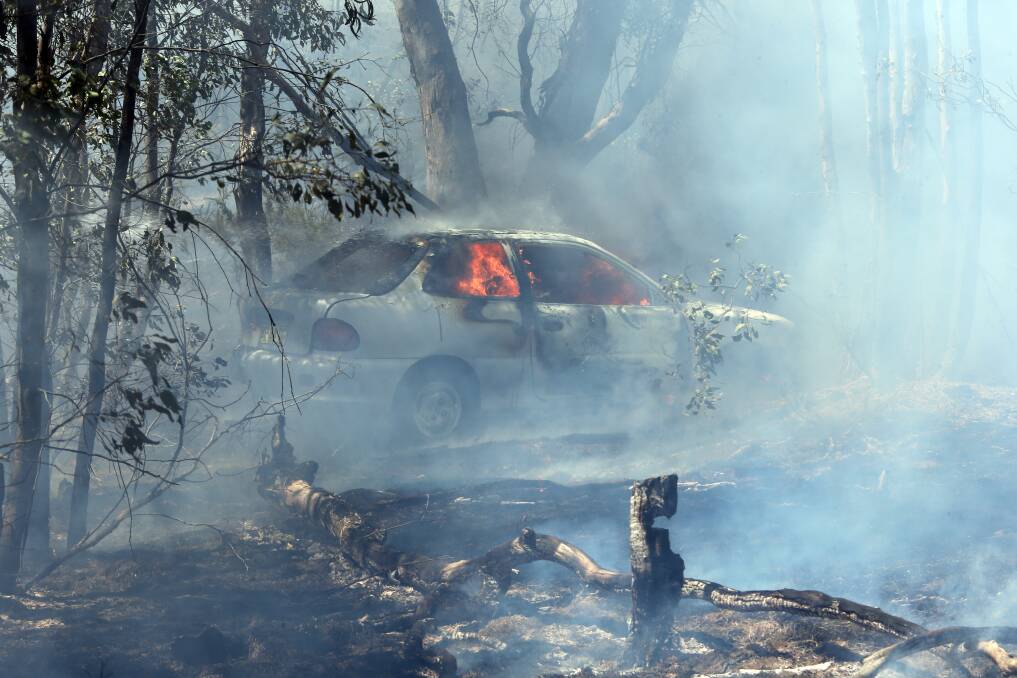 A torched car sparked the blaze that tore through 20 hectares of land at Nail Can Hill. Picture: PETER MERKESTEYN