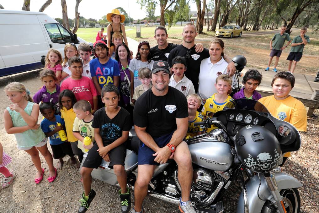 NRL stars Nathan Hindmarsh (front, centre), Brad Fittler, and Matt Cooper (rear, black t-shirts) visited the kids of West Albury as part of the Hogs for the Homeless tour they are doing, riding Harley Davidson motorbikes around NSW. Picture: MATTHEW SMITHWICK