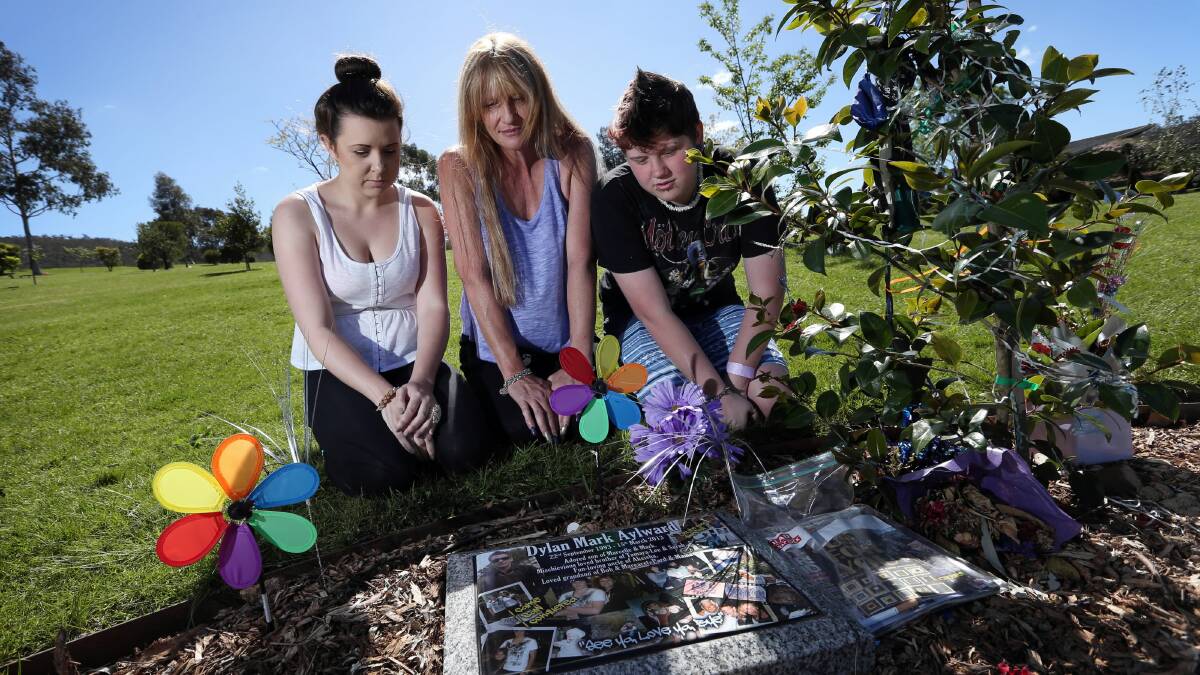 Tayla Crane, 19, Marcelle Rudd and her daughter Sarah Aylward, 17,  visit the memorial of Marcelle's son Dylan Aylward who died in March after crashing his motorbike. 