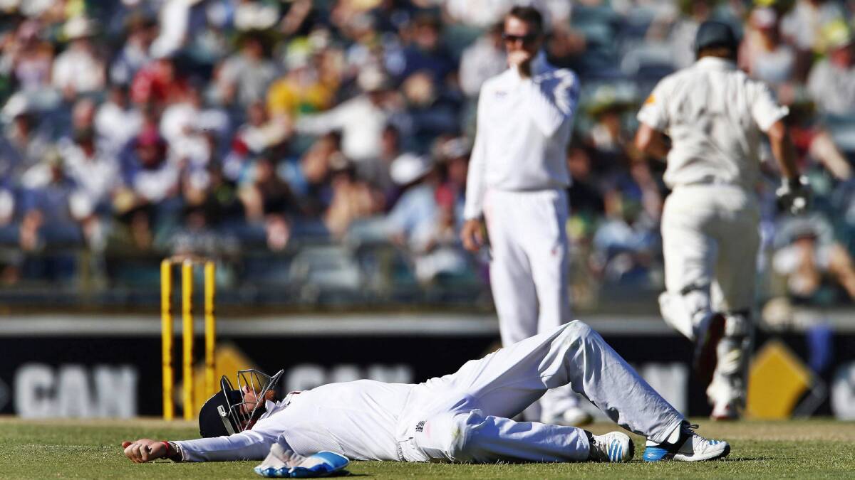 England's Ian Bell lies on the ground after he dropped a catch hit by Australia's  David Warner. Picture: REUTERS