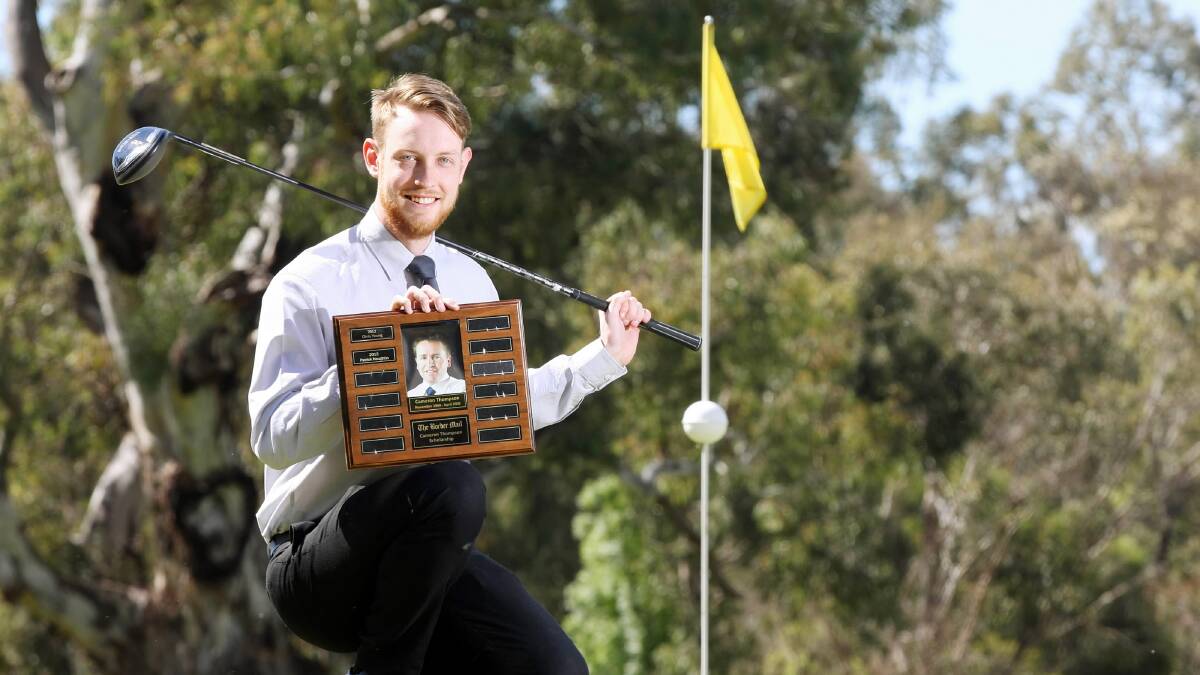 Patrick Naughtin holds the Cameron Thompson scholarship trophy yesterday. Picture: JOHN RUSSELL
